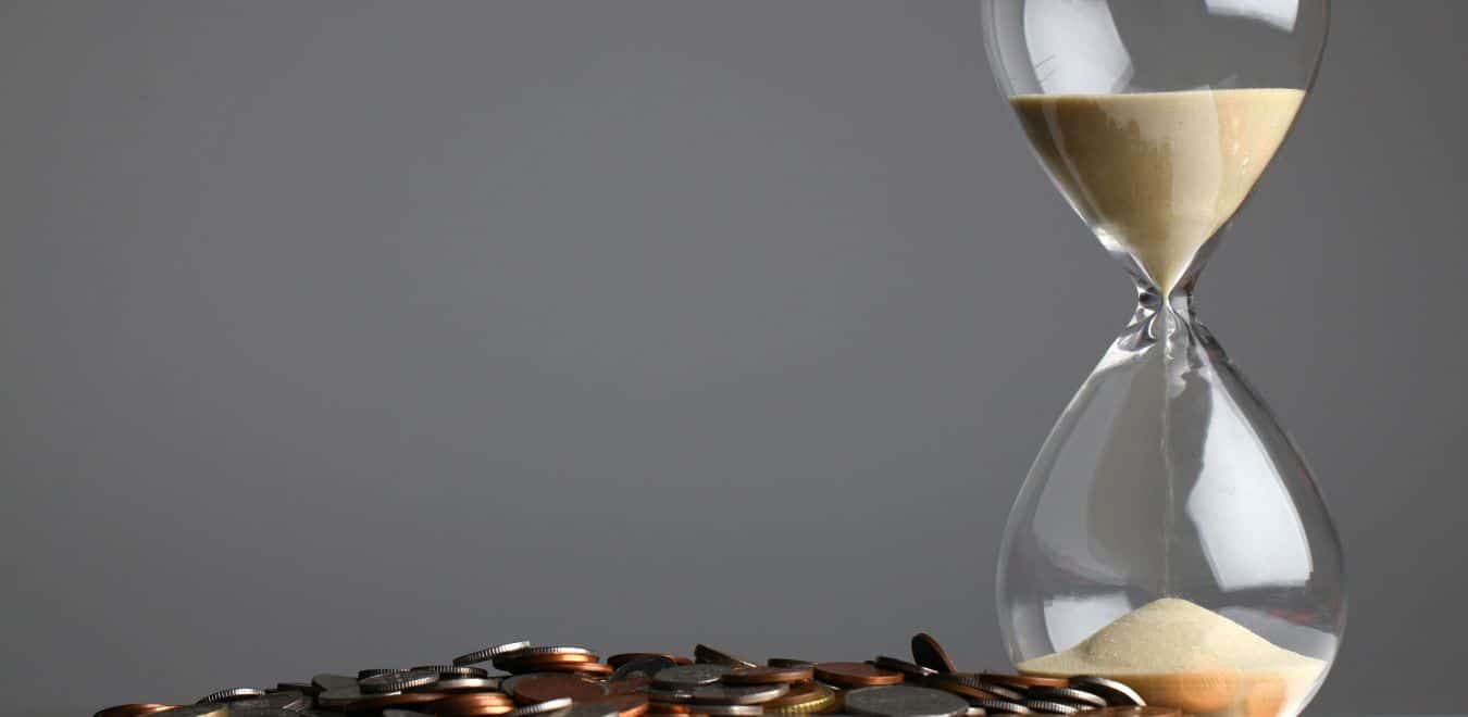 hourglass and coins representing shortening a sales cycle