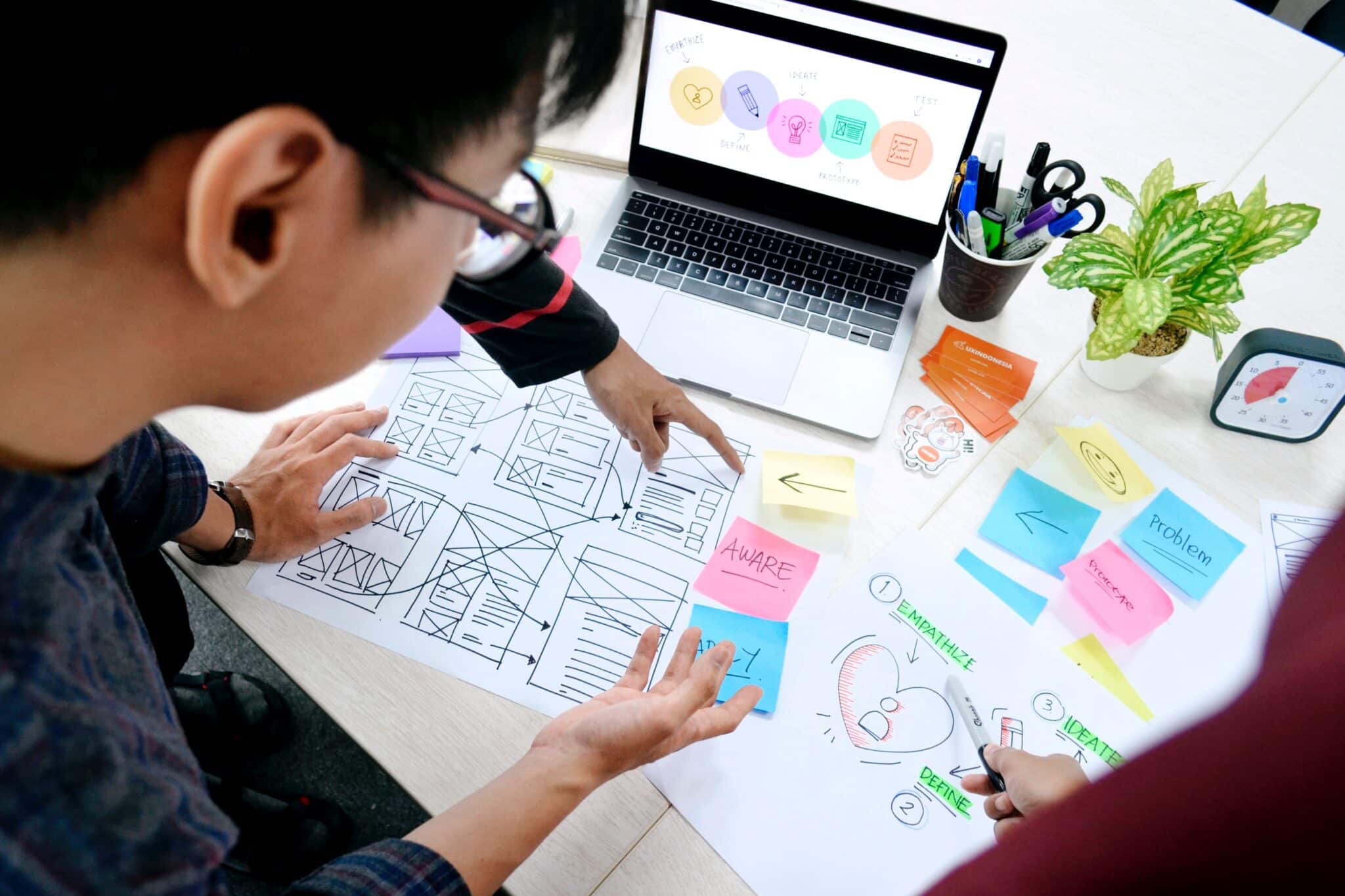 Two people looking at a business plan discussing next steps.